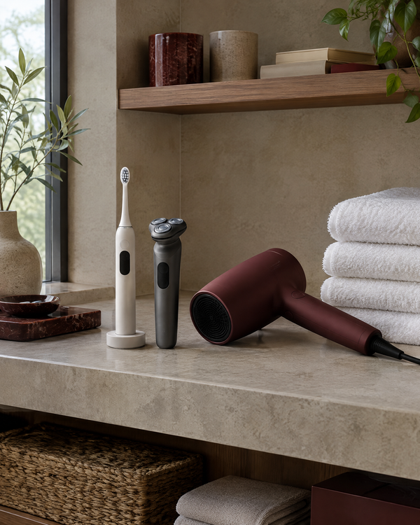 Bathroom shelf with an electric toothbrush, shaver, hair dryer and folded white towels